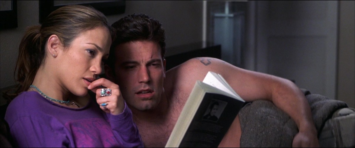 J.Lo and Ben Affleck reading a book in bed