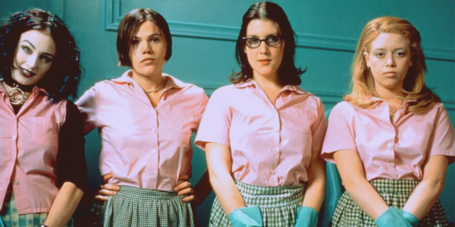 Four actors from But i'm a cheerleader standing next to each other in matching pink shirts.