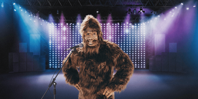 a bigfoot at a microphone