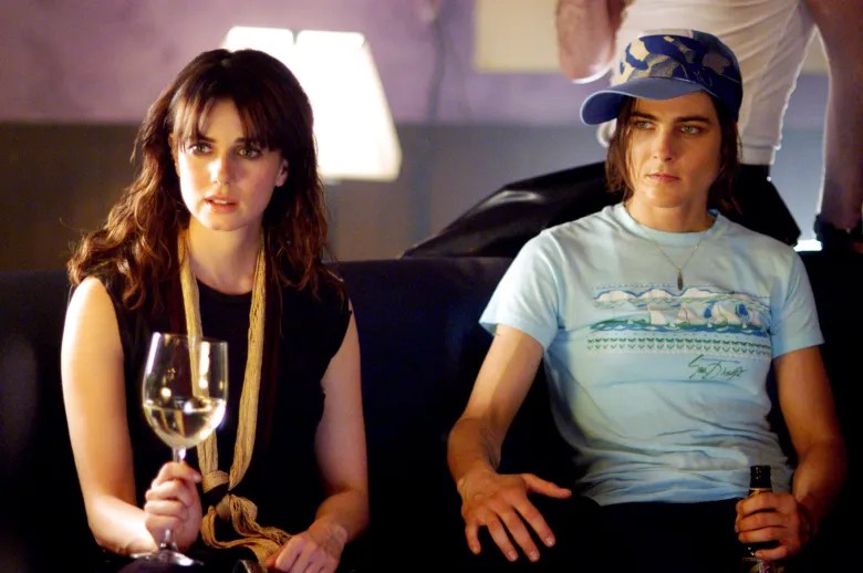 Max in a blue t-shirt and dark blue cap sitting next to Jenny on a couch