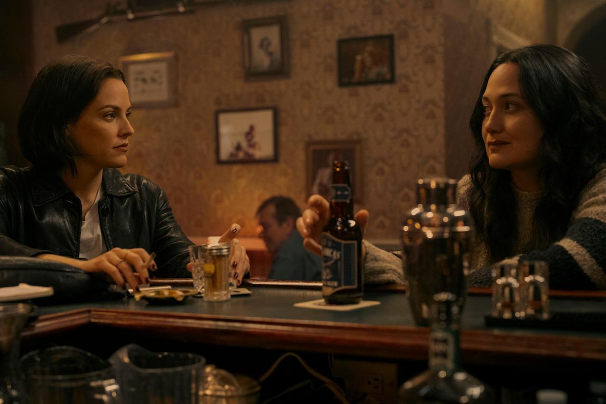 Under The Bridge -- “Blood Oath” - Episode 103 -- Upsetting news shakes the small town of Victoria, and as rumors surface, Rebecca and Cam reconnect. In the past, Reena enters Josephine’s mafia fantasy world. Rebecca (Riley Keough) and Cam (Lily Gladstone), shown. (Photo by: Darko Sikman/Hulu))