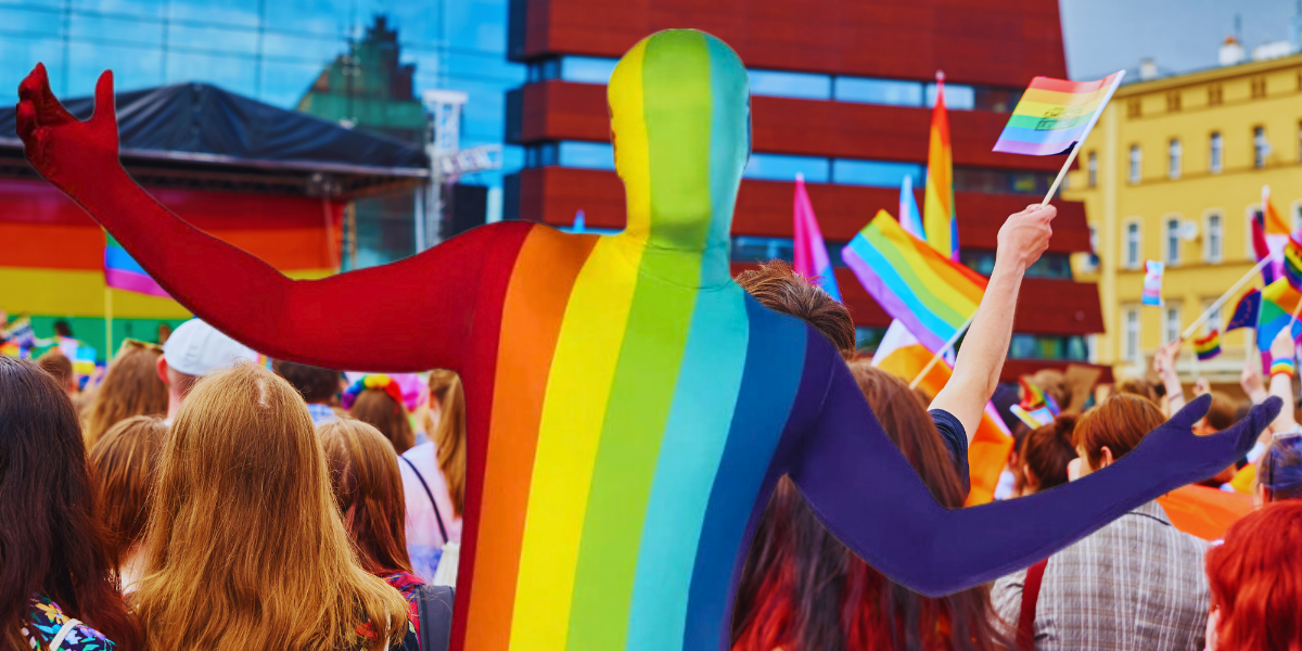 a person in a rainbow bodysuit at a Pride event