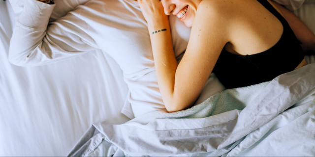 a person smiling in bed