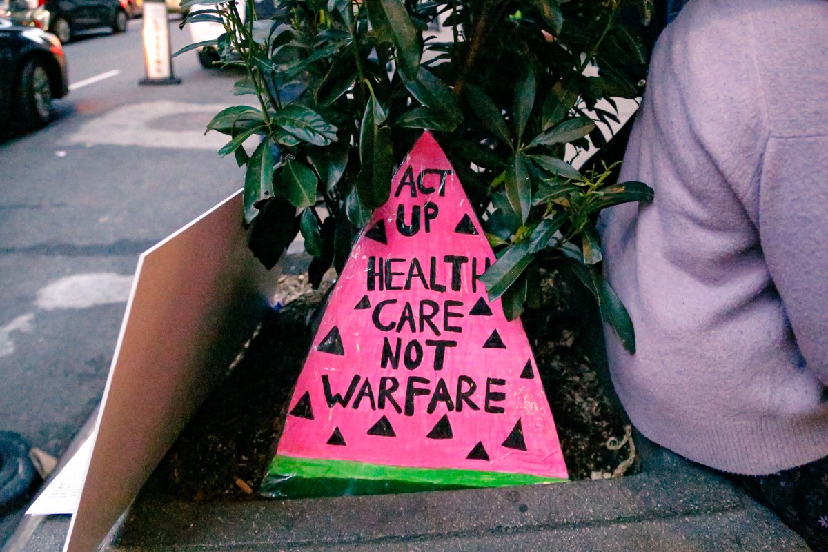 A sign that reads HEALTHCARE NOT WARFARE