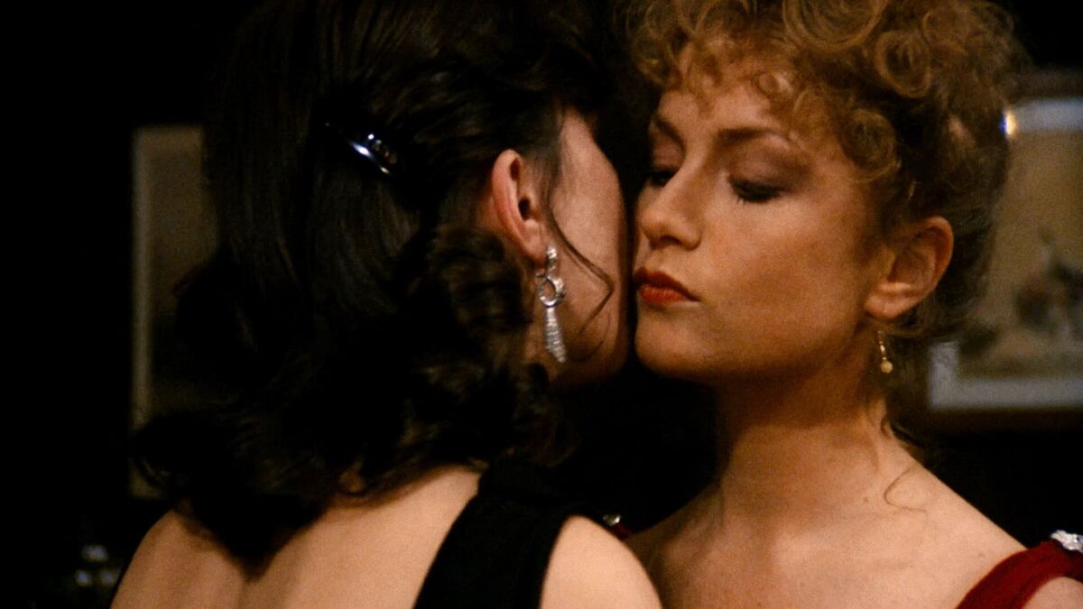 Cannes lesbian movies: Isabelle Huppert kisses Lili Monori's cheek in a close up.