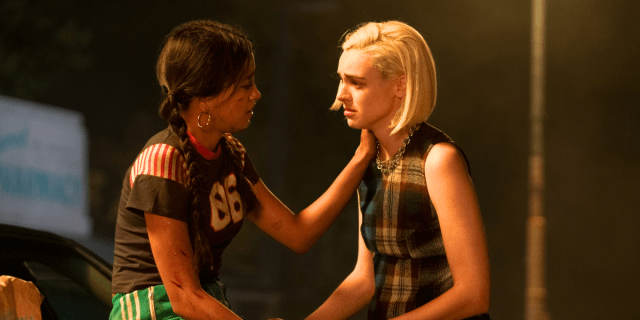 Pretty Little Liars Summer School - two girls one blonde with short hair, one brunette with long braids, share an emotional embrace