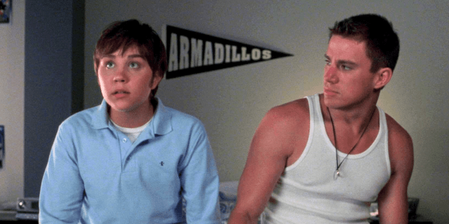 She's the Man trans: Channing Tatum in a white tank top looks at Amanda Bynes in drag.