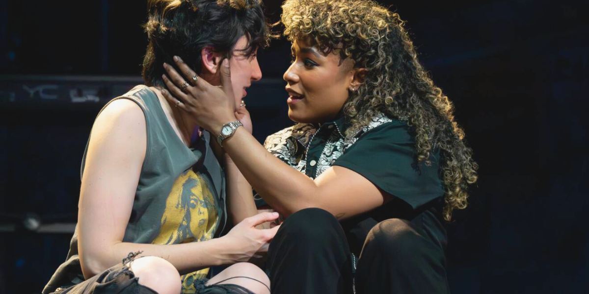 Taylor Iman Jones and Lauren Patten embrace on-stage in The Lonely Few
