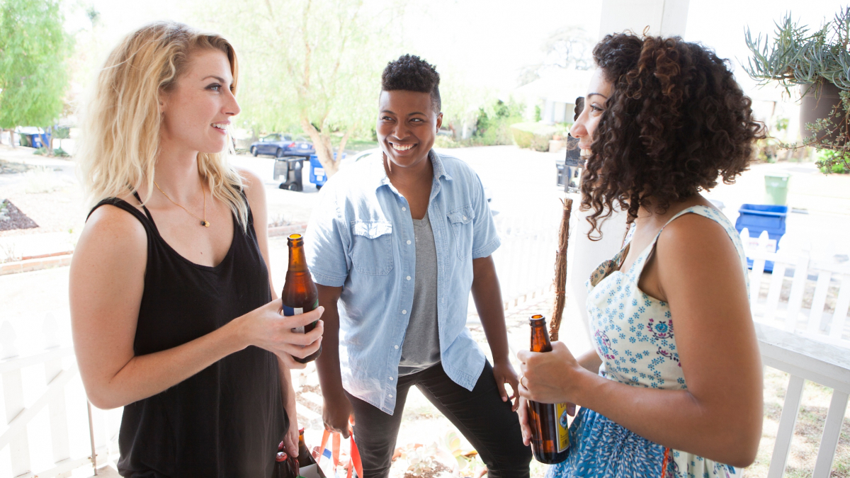 Lindsay Hicks, Brittani Nichols, and Jasika Nicole stand around laughing.