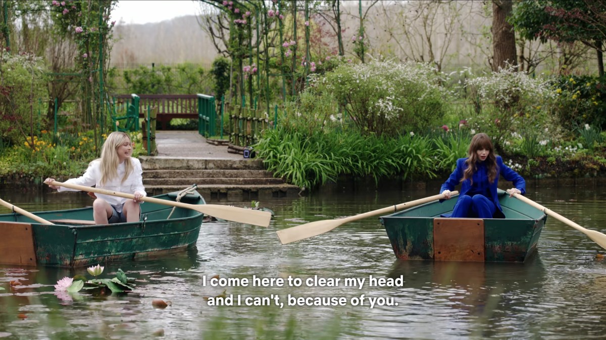Camille shoving Emily's rowboat with her oar