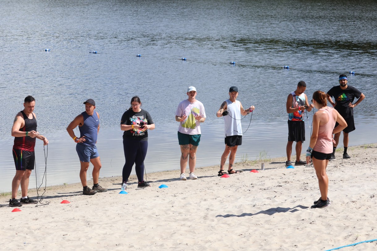 a group of queer people on a lake