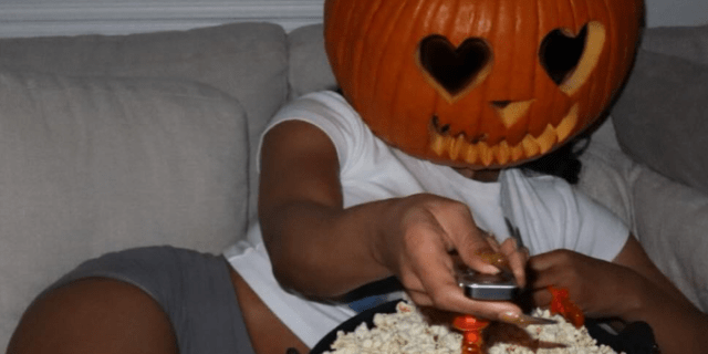 Megan Thee Stallion wearing a jack-o-lantern head