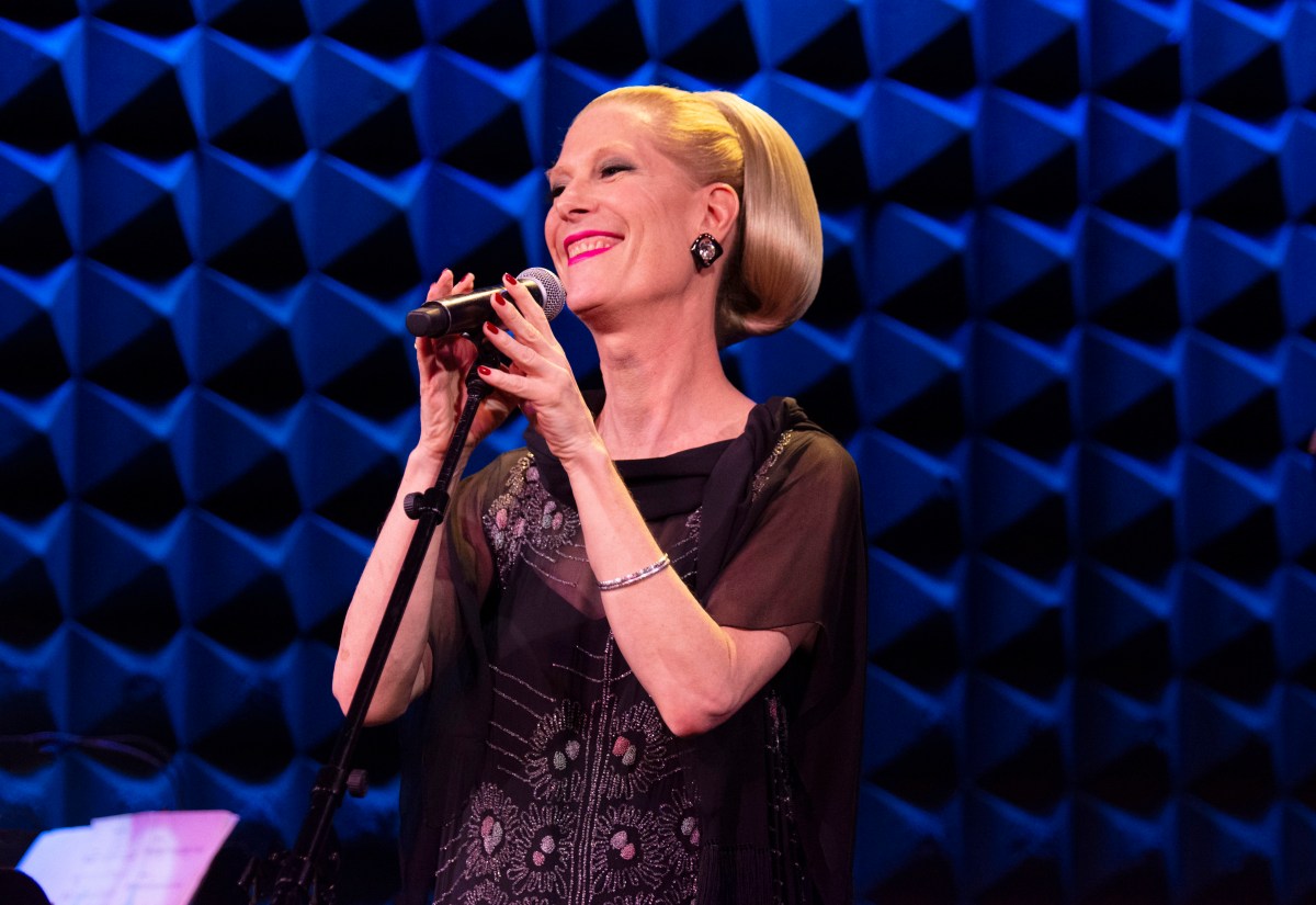 Justin Vivian Bond sings on stage smiling