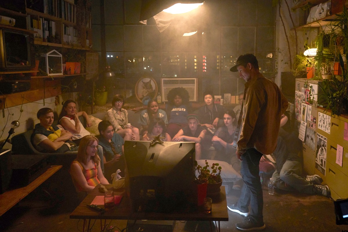 In a room full of queer and trans actors, director Rhys Ernst looks at a 2006 era tv with the cast.