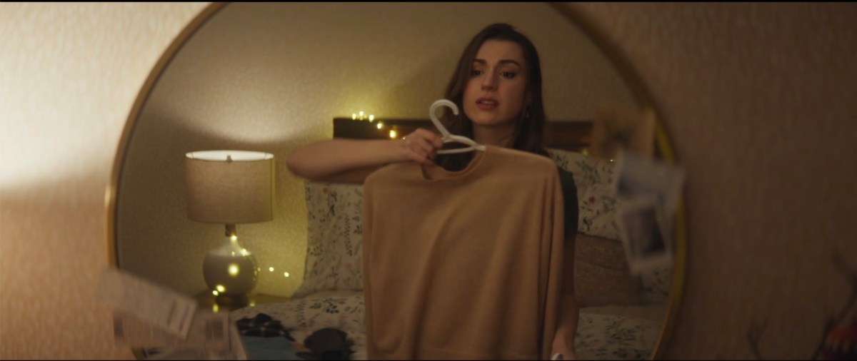 holding up a sweater