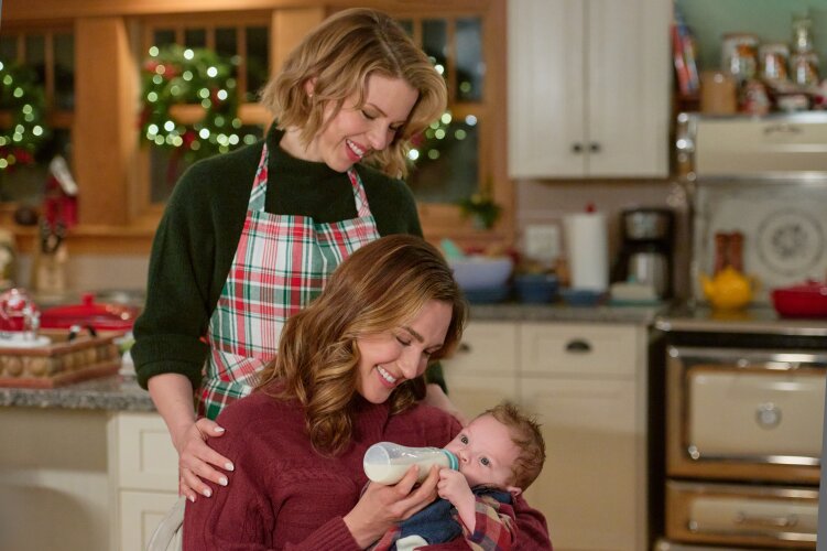 two lesbians holding a christmas baby
