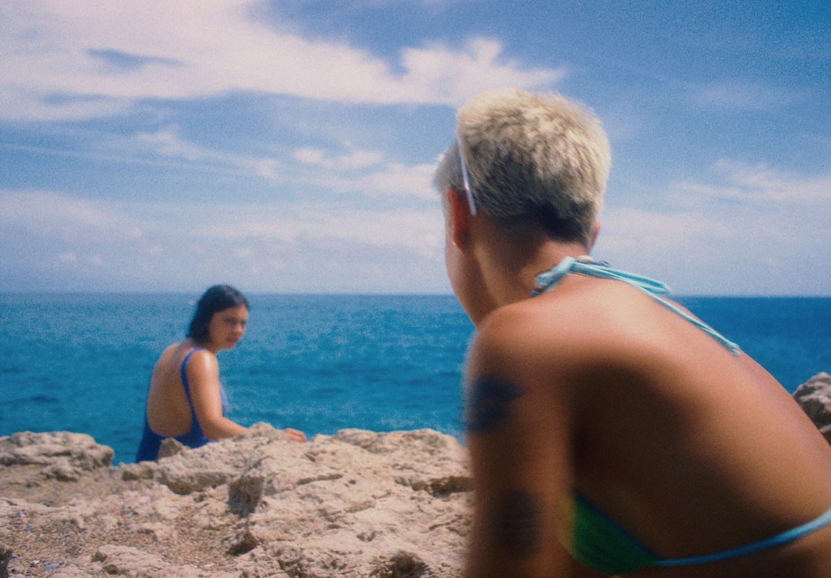 Raina Landolfi and Rita Roca gaze at each other on a rocky beach in Ripe!