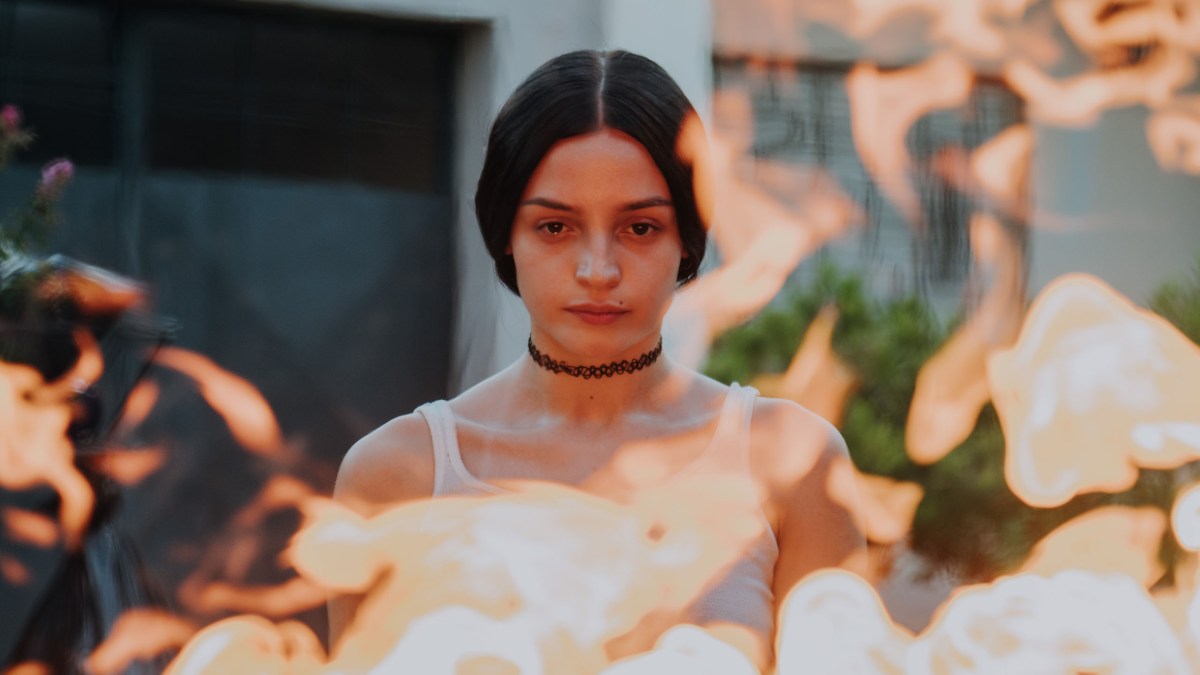 Dolores Oliverio looks into flames in The Virgin of Quarry Lake