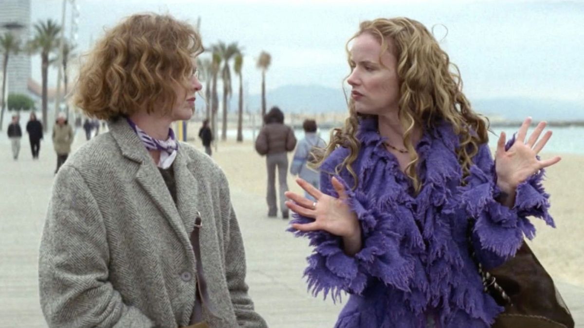 Judy Davis talks to Juliette Lewis who is wearing a feathery purple coat.
