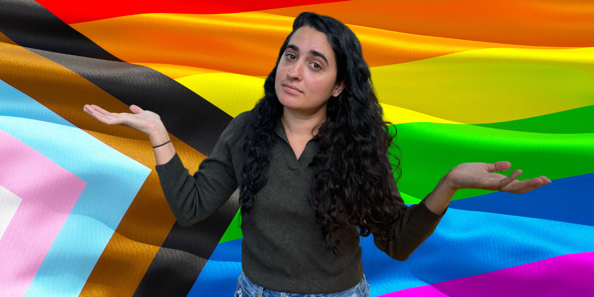 Kayla shrugging with a gay flag behind her