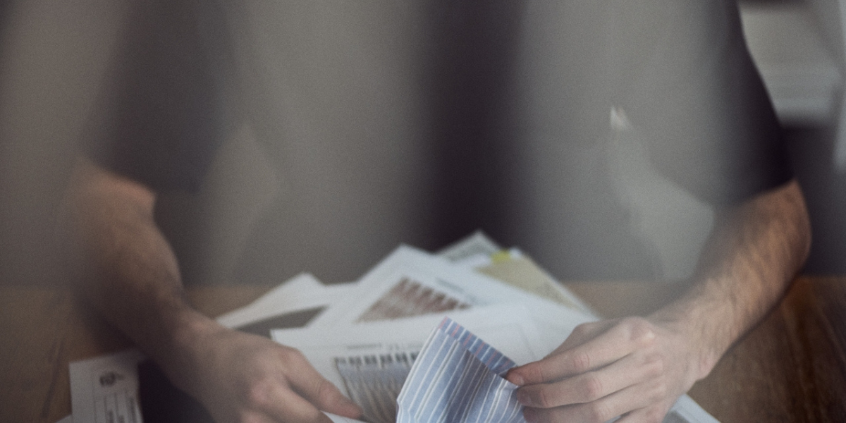 a person holding a bunch of documents