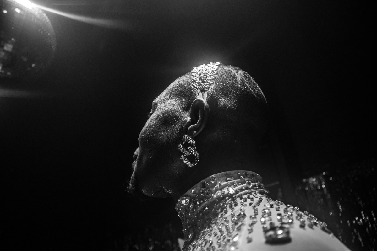 a ballroom performer wearing a jeweled headpiece and bedazzled mock neck