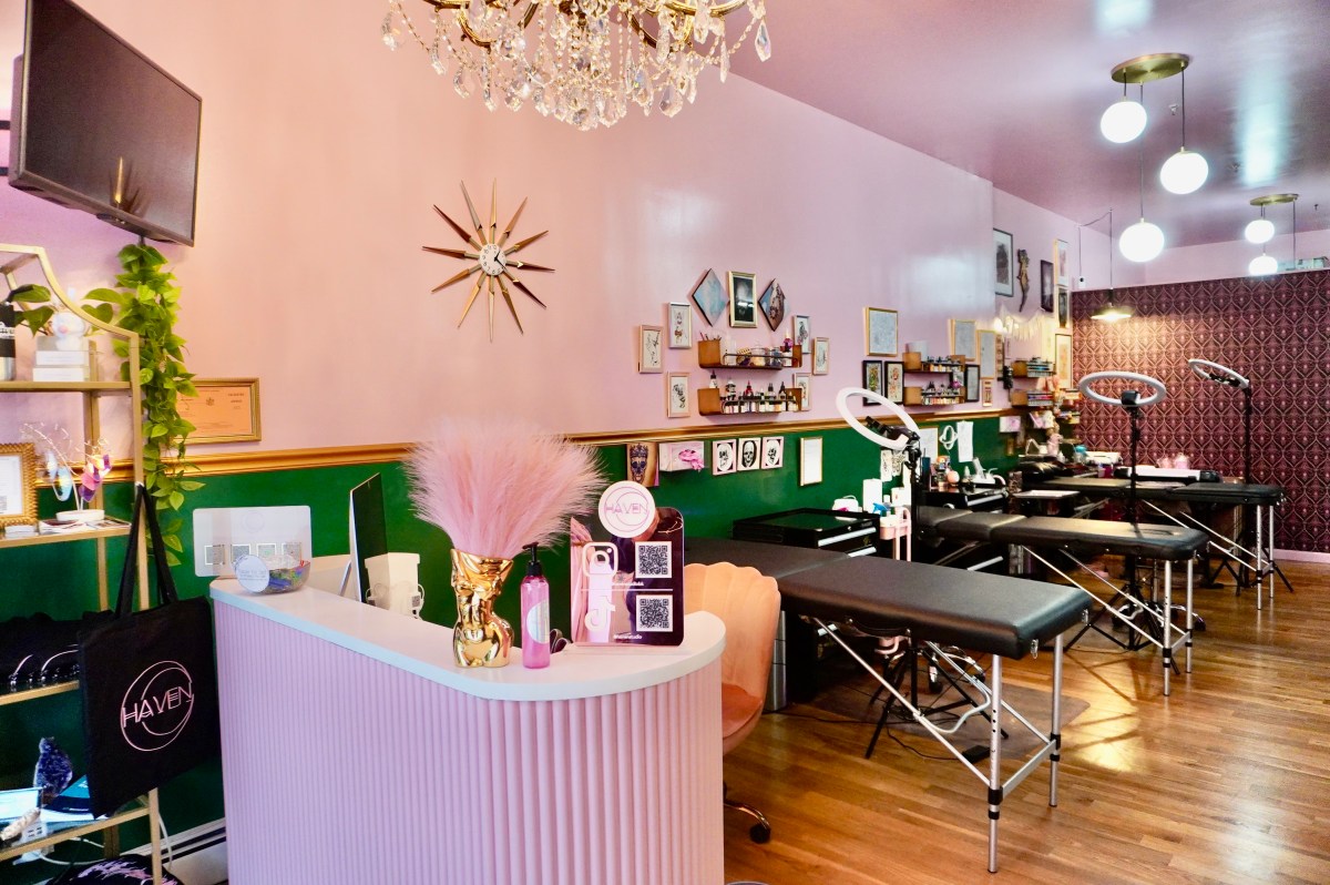 Four tattoo tables lined up at Haven, a parlor with a pink feminine aesthetic. 