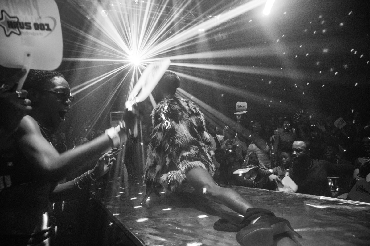 a ballroom performer in the splits wearing a fur coat