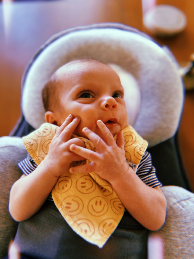jude with his hands on his little baby mouth
