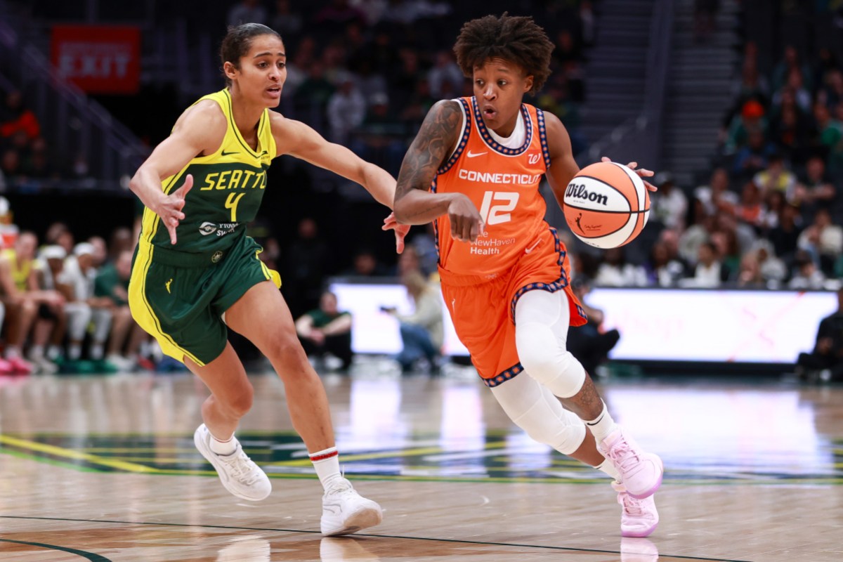 SEATTLE, WASHINGTON - MAY 04: Yvonne Anderson #12 of Connecticut Sun drives against Skylar Diggins-Smith #4 of Seattle Storm during the second quarter of a preseason WNBA game at Climate Pledge Arena on May 04, 2025 in Seattle, Washington. NOTE TO USER: User expressly acknowledges and agrees that, by downloading and or using this photograph, User is consenting to the terms and conditions of the Getty Images License Agreement. (Photo by Rio Giancarlo/Getty Images)