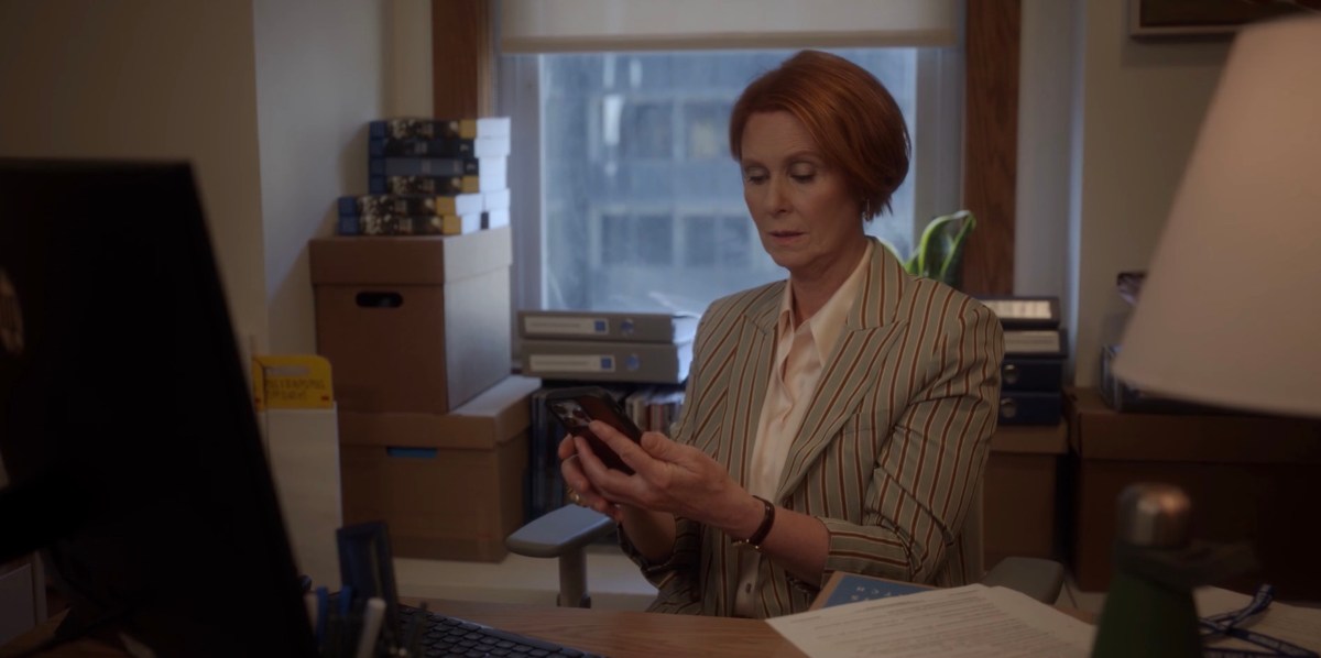 Miranda at her desk with her phoen