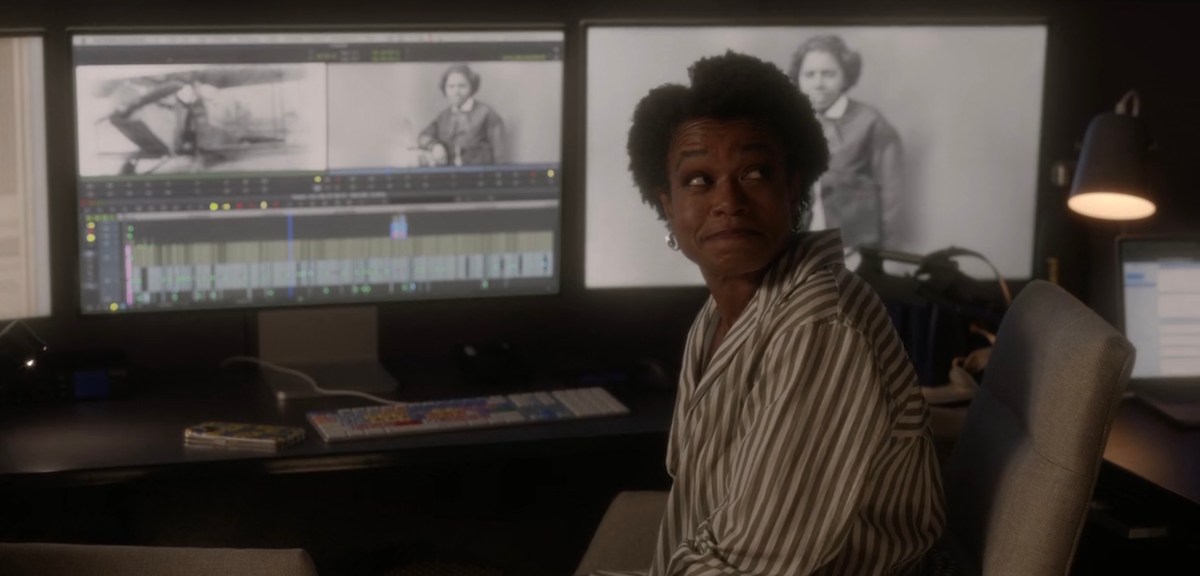 character sitting in front of the monitor