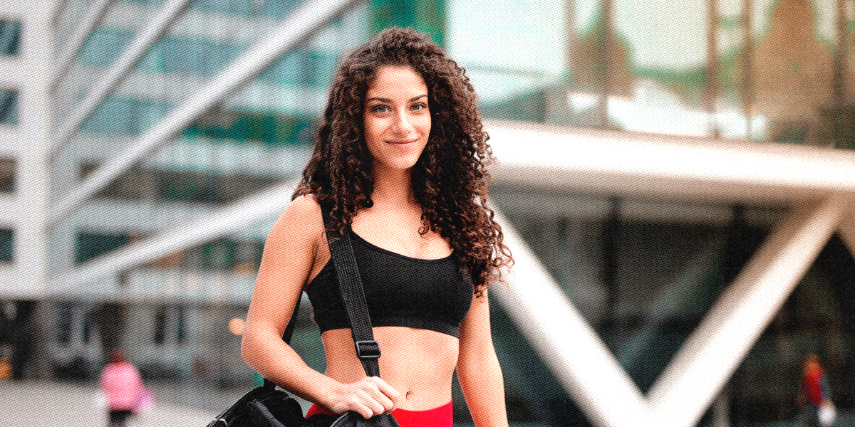 What straight person are you quiz: a random stock photo of woman in a sports bra carrying a gym bag