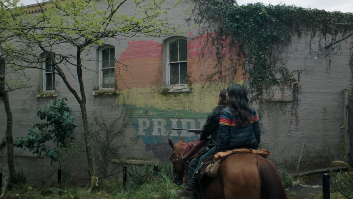 The Last of Us 204: Ellie and Dina ride Shimmer past a Pride mural