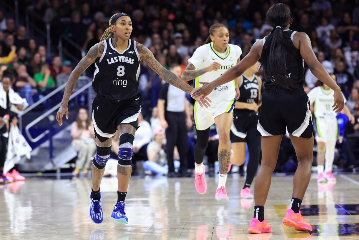 SOUTH BEND, INDIANA - MAY 02: Crystal Bradford #8 of the Las Vegas Aces reacts with Jackie Young #0 of the Las Vegas Aces against the Dallas Wings during the preseason game at Purcell Pavilion on May 02, 2025 in South Bend, Indiana.