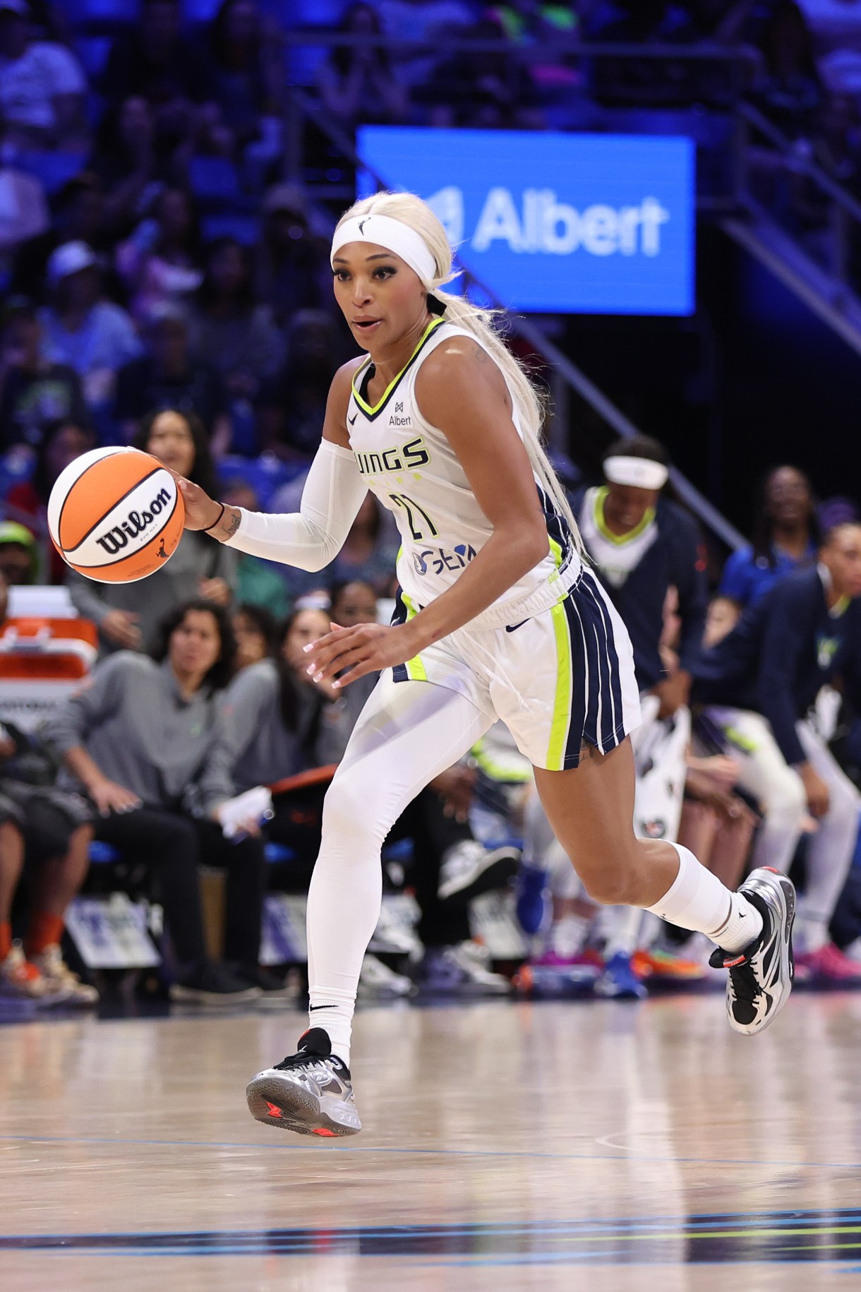 ARLINGTON, TEXAS - MAY 10: DiJonai Carrington #21 of the Dallas Wings controls the ball during the second half of a preseason game against the Toyota Antelopes at College Park Center on May 10, 2025 in Arlington, Texas.