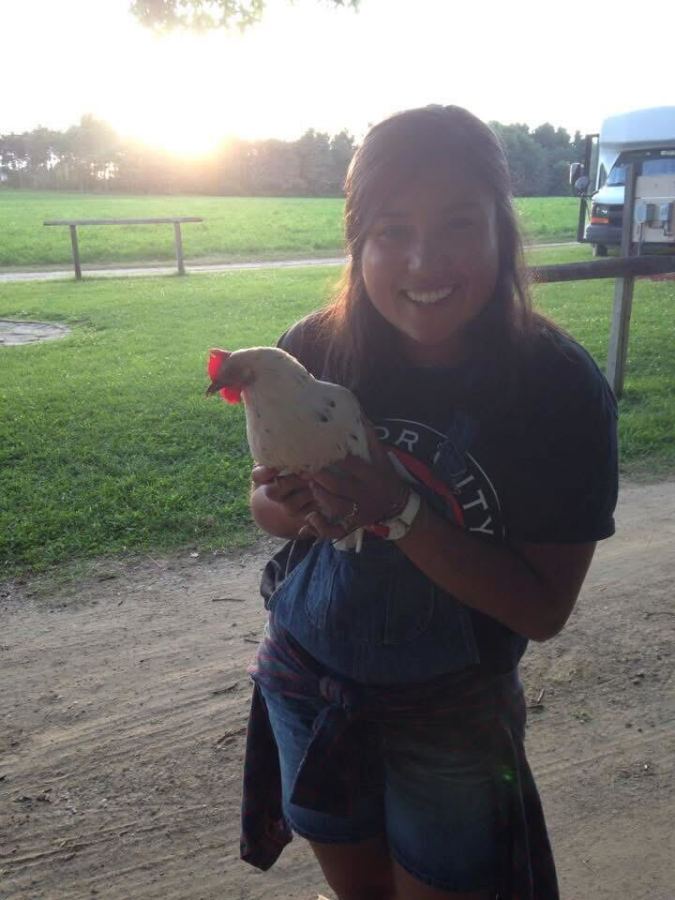 Em Win holding a chicken