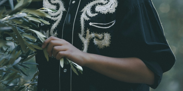masc lesbian holding flower