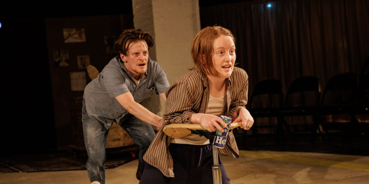 Bobbi Salvör Menuez leans on a rolling stool as Jess Barbagallo pulls at their shirt in Bad Stars