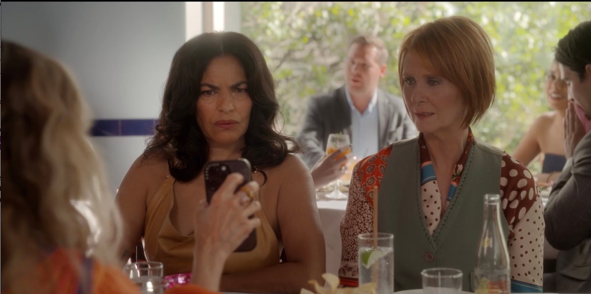 miranda and seema scowling at a phone