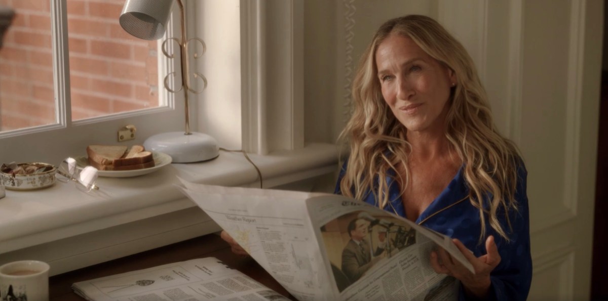 carrie holding the newspaper