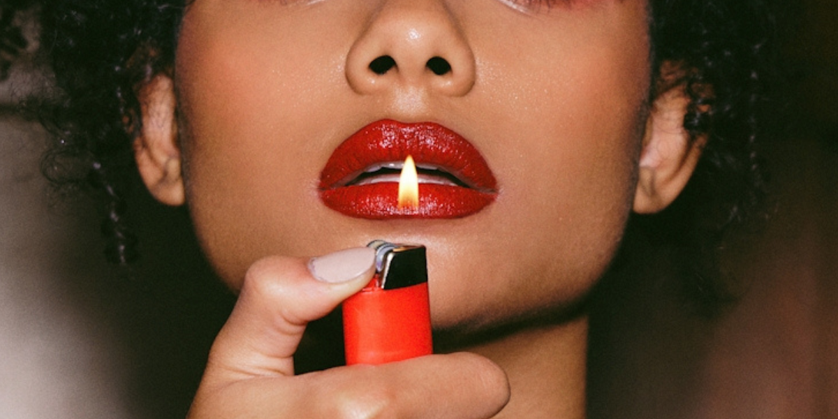 a woman with a lighter in front of her face