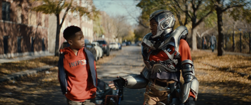 screenshot of landon walking with riri as she wears her broken iron suit