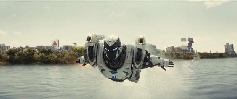 Riri flying in iron suit over a body of water