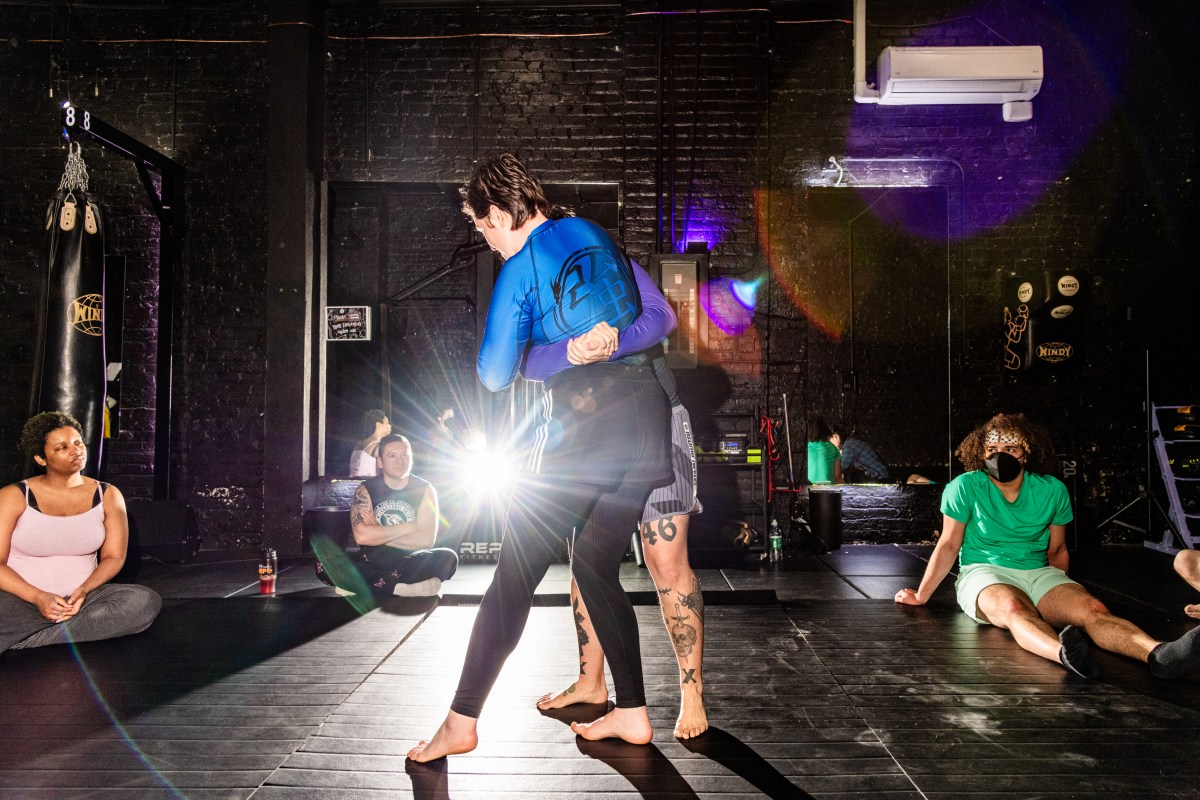Irina Groushevaia, center left, and parter Mylo Mendez, center right, begin the jiu-jitsu training starting with a standing pose.