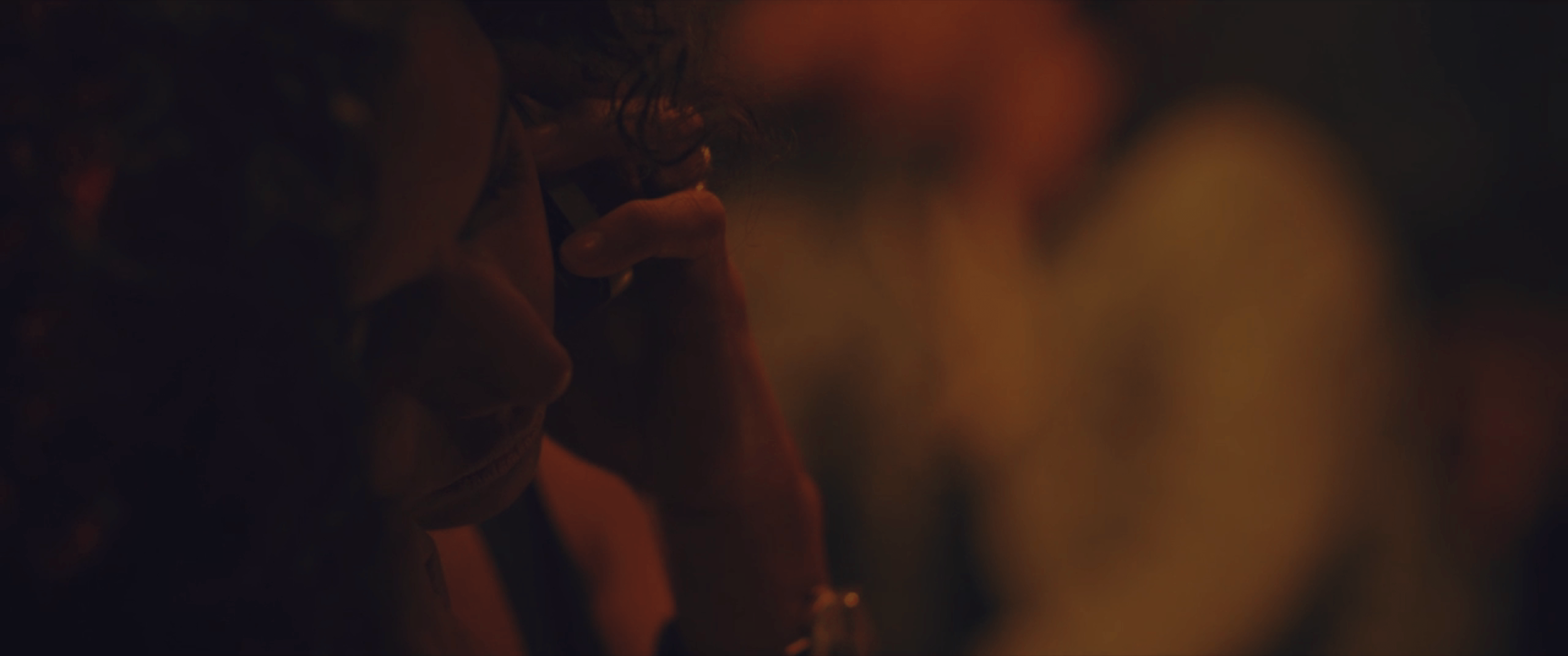 Alejandra Lara sits on the phone in the side of the frame in Eva + Candela