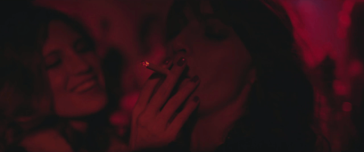 Silvia Santamaría takes a drag of a cigarette in a night club in Eva + Candela