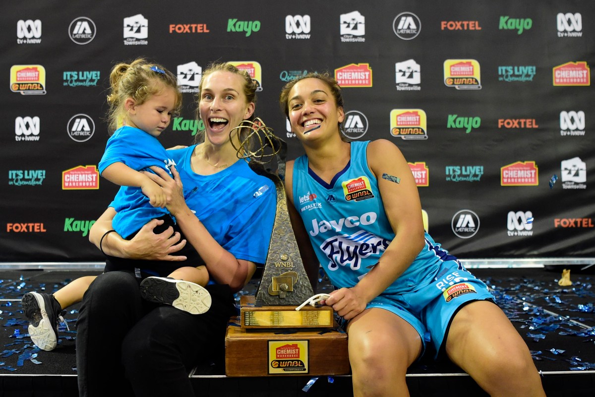 TOWNSVILLE, AUSTRALIA - DECEMBER 20: Leilani Mitchell of the Flyers celebrates with partner Mikaela Dombkins and son Kash after winning the WNBL Grand Final match between the Southside Flyers and the Townsville Fire at the Townsville Stadium, on December 20, 2020, in Townsville, Australia. (Photo by Ian Hitchcock/Getty Images)