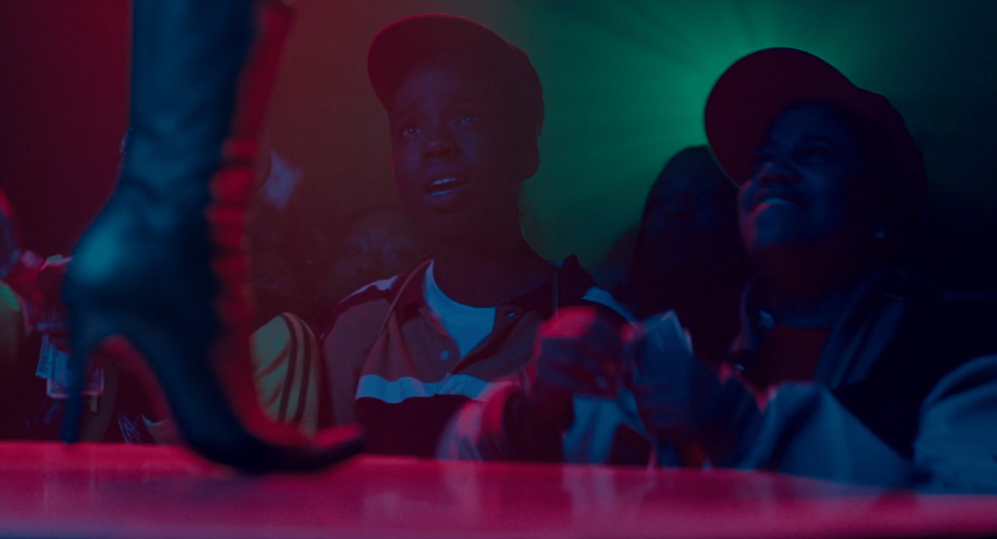 The best lesbian night club scenes: Alike looks up at a dancer on stage in Pariah