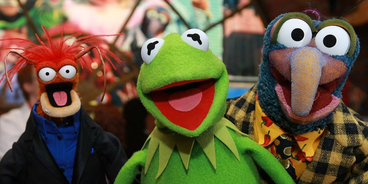 A gay history of the Muppets Pepe the Prawn, Kermit the Frog, and Gonzo smile at the camera